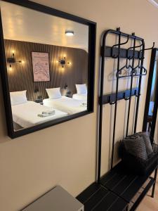 a mirror on the wall of a bedroom with a bed at Hotel Le Relais de Pommard in Francorchamps +21 photos