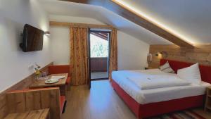 a hotel room with a bed and a window at Hotel Garni Schieferle in Innsbruck +63 photos