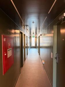 a corridor of a hallway with a long hallway at AMISTAT Hub Hostel Budapest in Budapest
