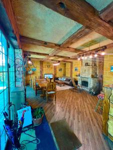 a large living room with a table and a fireplace at Villa Loft in Balaovit