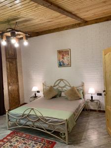 a bedroom with a metal bed with two pillows at Villa Loft in Balaovit +66 photos