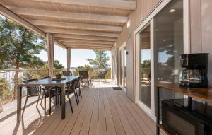 a screened porch with a table and chairs on it at Mobile home Azzurro in Drage