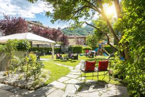 a garden with two chairs and a playground at Palazzo Pellanda in Domodossola