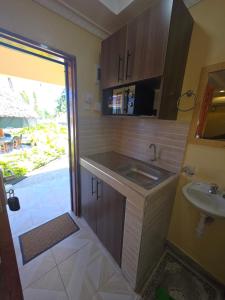 a small bathroom with a sink and a mirror at The Hidden Paradise in Mombasa