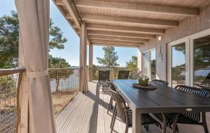 a porch with a table and chairs on a deck at Mobile home Azzurro in Drage