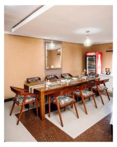 a large dining room with a long table and chairs at Leon's Hotel in Choma
