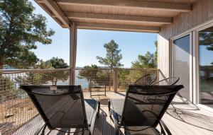 two chairs sitting on the porch of a house at Mobile home Azzurro in Drage