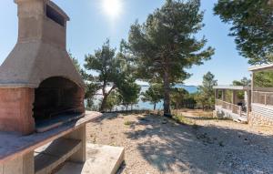 an outdoor oven with a view of the ocean at Mobile home Azzurro in Drage