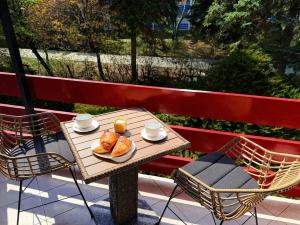 a table with a plate of croissants on a balcony at Csopaki promenade in Csopak