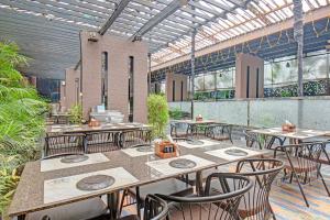 a restaurant with tables and chairs in a building at FabHotel New Moshi Grrand in Pune
