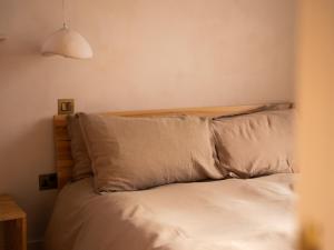 a bed with white sheets and pillows in a bedroom at Yarn - Milo Deluxe King Suite in Ballycastle