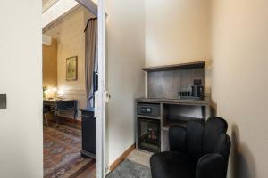 a living room with a fireplace and a chair at Hotel Palazzo Borghini - Gruppo Estella Hotels in Florence +54 photos