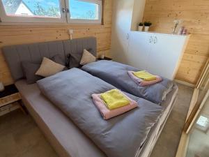 a large bed in a room with two pillows on it at Tiny House 3 Küstenlicht in Freest +20 photos
