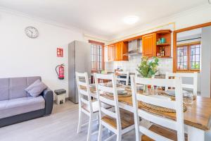 a kitchen and dining room with a table and chairs at Villa Els Pins in El Arenal +17 photos
