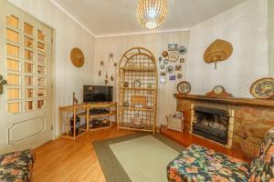 a living room with a fireplace and a television at Excellent location, good access to the beach in Vila do Conde