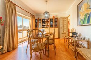 a dining room with a table and chairs and a window at Excellent location, good access to the beach in Vila do Conde
