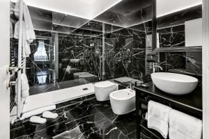 a black and white bathroom with a toilet and a sink at Hotel Palazzo Borghini - Gruppo Estella Hotels in Florence