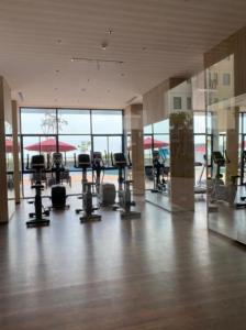 a gym with many exercise equipment in a building at Osaka riverview Apartment PIK 2 by SS in Rawalumpang