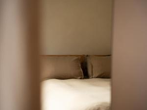 a bed with white sheets and pillows in a room at Yarn - Milo Deluxe King Suite in Ballycastle +5 photos