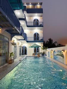 a swimming pool in a building with a large pool at Laco Villa in Danang