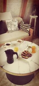 a coffee table with a tea pot and food on it at La Kabanetik in La Tacherie