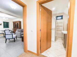 a room with a door leading to a living room at Casa da Estação in Torre de Moncorvo +30 photos