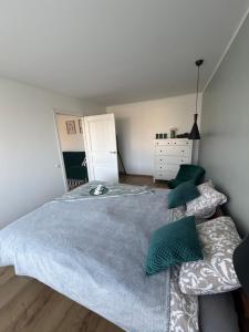 a bedroom with a large bed with green pillows at Cozy Apartment In Sigulda in Sigulda