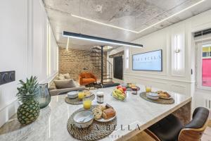 a living room with a table with food on it at KAZA BELLA - Malakoff in Malakoff