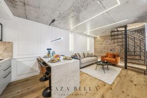 a kitchen and living room with a couch and a table at KAZA BELLA - Malakoff in Malakoff
