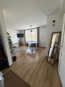 a living room with a table and a mirror at Cozy Apartment In Sigulda in Sigulda