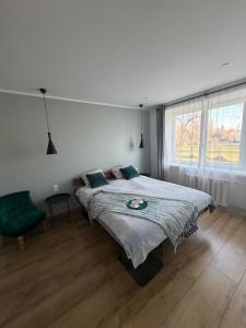 a bedroom with a large bed and a window at Cozy Apartment In Sigulda in Sigulda