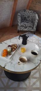 a table with a tea pot and food on it at La Kabanetik in La Tacherie +17 photos