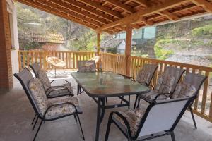 a patio with a table and chairs on a deck at Vila Dragica in Bogutovac