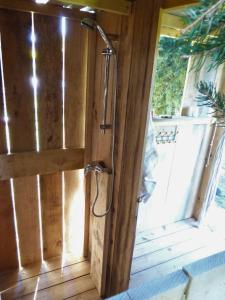 a shower in a wooden door in a room at Nid et Toiles in Bernadets-Debat +69 photos