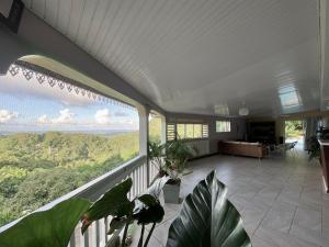 a large porch with a view of the mountains at La Villa Rosier in Le François