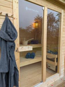 a wooden sauna with a towel in the window at Landhaus Freche Socke in Buchhorst +35 photos