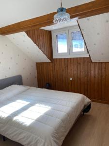 a bedroom with a white bed and a window at Sous l'Alpette en Chartreuse in Saint-Pierre-dʼEntremont +15 photos