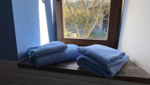 a couple of blue towels sitting on a window sill at Mas Casalprim in Sant Feliu de Pallerols