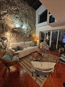 a living room with a couch and a stone wall at Villa Magnet in Lozenets
