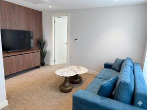 a living room with a blue couch and a table at Hotel Riva in Budva +41 photos