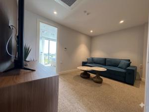 a living room with a blue couch and a table at Hotel Riva in Budva