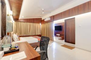 a hotel room with a bed and a desk and a room at FabHotel High Five - Nr Vagator Beach in Assagao