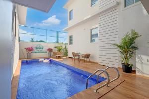 a swimming pool in the middle of a house at FabHotel High Five - Nr Vagator Beach in Assagao
