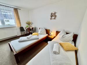 a hotel room with two beds and a table at Villa Slnecnica in Nová Lesná
