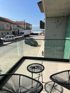 two chairs and a table on a balcony at casa da Inês in Vieira de Leiria