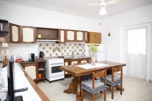 a kitchen with a wooden table and a kitchen with a stove at Alta Marea in Fossacesia