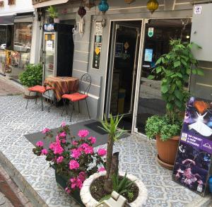 a table and flowers outside of a store at Theodora Hostel in Istanbul