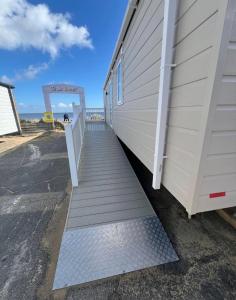a stairway leading up to a building on the beach at SEA VIEW CARAVAN Disability friendly in Caister-on-Sea