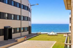a view of the ocean from a building at Oporto Beach Apartment in Vila Nova de Gaia