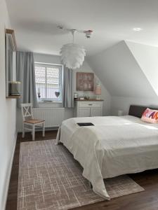 a bedroom with a large white bed and a window at Schloß Falkenhaus in Bad Berneck im Fichtelgebirge